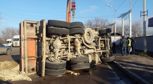 Груженый "КамАЗ" столкнулся с Lada и перевернулся в Алматы